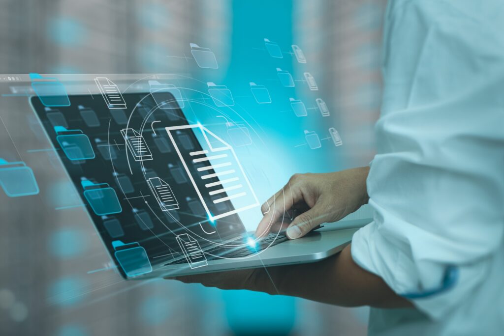 A healthcare worker using automation functions on a laptop for vendor case management