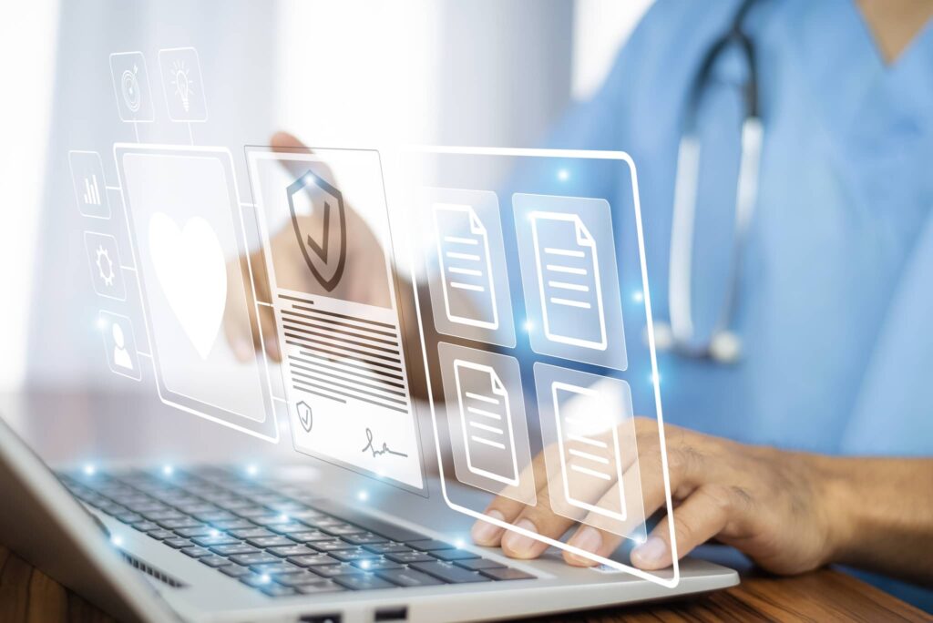 A healthcare professional using automated bill-only healthcare solutions at their desk on their laptop