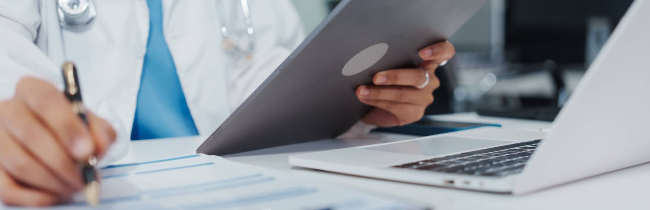 Doctor at their hospital desk reviewing bill-only process through casechek’s supply chain management solutions to improve workflows