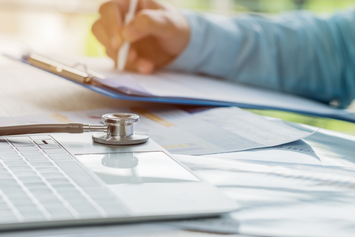 Medical billing documents and stethoscope representing hospital Bill-Only workflow complexity, manual reconciliation, and surgical billing accuracy